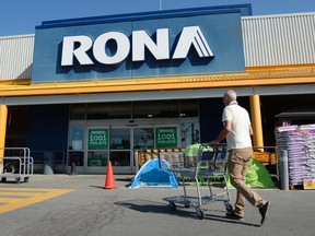 A customer heads towards the entrance of a Rona home improvement store in St. Eustache, Que., just outside Montreal, on Thursday, July 16, 2015. Rona Inc. says it intends to buy the 20 franchise stores in its retail network - including 18 in Quebec. The company didn't say how much it expects to pay and adds that the transaction will be subject to a review of the business at each of the franchised stores. THE CANADIAN PRESS/Ryan Remiorz