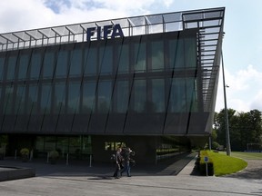 Members of the media walk in front of FIFA headquarters in Zurich, Switzerland, on May 27, 2015. (Ruben Sprich/Reuters)