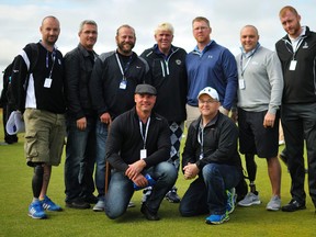Canadian veterans Stephen Dusyk (third from left), Kevin O'Brien and Yann Carpentier (third and second from right), and Gunther Mally and Don Hookey (bottom) pose with John Daly (centre) at St. Andrews on Wednesday, July 16, 2015.