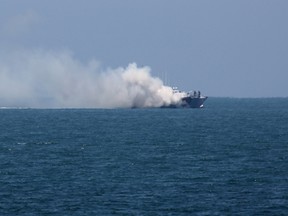 A picture shows smoke billowing from an Egyptian naval vessel on the maritime border between Egypt and the Palestinian Gaza Strip, off the coast of Rafah in southern Gaza, on July 16, 2015. (AFP PHOTO/SAID KHATIB)