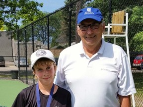 Little Caesars Junior Tennis Tour tournament convenor Bob McLeod presents Adam Osler a medal for winning the boy's under-10 championship Saturday in Sarnia. Osler, from Sarnia, defeated JP Lemak from Chatham 6-5 for first place.  (Handout/Sarnia Observer/Postmedia Network)