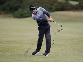 Graham DeLaet hits his second shot on the 15th hole during the first round of the British Open on the Old Course in St. Andrews, Scotland, July 16, 2015. (REUTERS/Russell Cheyne)