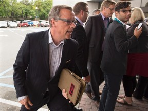 Saskatchewan Premier Brad Wall heads from a scrum with reporters at the summer meeting of Canada's premiers in St. John's on Thursday, July 16, 2015. THE CANADIAN PRESS/Andrew Vaughan