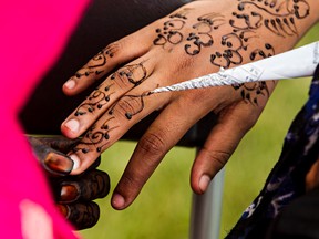 A girl has her hand painted with a henna tattoo during Eid celebrations at 118 Avenue and 91 Street in Edmonton, Alta., on Saturday, Aug. 2, 2014. Codie McLachlan/Edmonton Sun