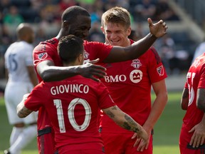 Toronto FC midfielder Sebastian Giovinco (10) celebrates his goal with forward Jozy Altidore (17) and defender Nick Hagglund (6) during the first half against the Philadelphia Union at PPL Park. Bill Streicher-USA TODAY Sports