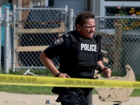 Ottawa police surrounded the area of Lilas Private after a early morning shooting in Ottawa Tuesday July 14, 2015. Ottawa police tactical team surrounded a house and took one man into custody. One man was taken to hospital with gun wounds.  Tony Caldwell/Ottawa Sun/Postmedia Network