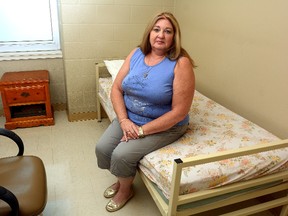 Martha Connoy, director of the community mental health program at Mission Services, sits on one of the crash beds in the women?s section of Mission Services on Thursday. (MORRIS LAMONT, The London Free Press)