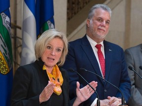 Alberta Premier Rachel Notley responds to reporters questions as Quebec Premier Philippe Couillard, right, looks on, Tuesday, July 14, 2015 at a news conference following a meeting in Quebec City. The Canadian Press/Jacques Boissinot