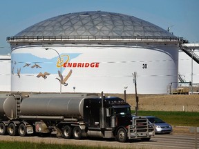 A storage tank looms over a freeway at the Enbridge Edmonton terminal in Edmonton August 4, 2012. REUTERS/Dan Riedlhuber