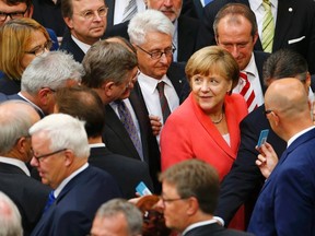 German Chancellor Angela Merkel prepares to vote during the session of Germany's parliament, the Bundestag, in Berlin, Germany, July 17, 2015. (REUTERS/Axel Schmidt)