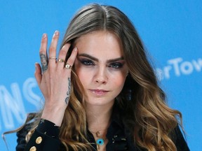 Cast member Cara Delevingne poses for photos at a photo call promoting her film "Paper Towns" at Claridges in London, Britain June 18, 2015.  REUTERS/Suzanne Plunkett