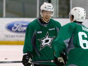 Wonjun Kim (left) of South Korea, speaks with fellow South Korean Jinhui Ahn during a Dallas Stars development hockey camp at the team's practice facility in Frisco, Texas, on Thursday, July 9, 2015. South Korean players from the Asia League Ice Hockey are working out with the Stars. (LM Otero/AP Photo)