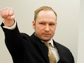 Norwegian mass killer Anders Behring Breivik gestures as he arrives for his terrorism and murder trial in a courtroom in Oslo April 16, 2012. (REUTERS/Heiko Junge/Pool)
