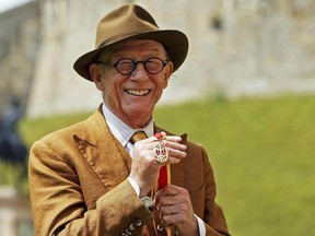 British actor John Hurt poses with his award after receiving a knighthood by Queen Elizabeth during an investiture ceremony at Windsor Castle in Windsor, Britain July 17, 2015.  REUTERS/Steve Parsons/pool