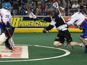The Edmonton Rush's Matthew Dinsdale (61) makes a diving shot against the Toronto Rock's Brandon Miller (35), while being chased by Sandy Chapman (5) during second half NLL Champions Cup Finals action at Rexall Place, in Edmonton Alta. David Bloom/Edmonton Sun