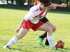 Mikayla Howard (white jersey) of the West City Honda U18 girls Belleville Comets battles a St. Lawrence United foe during rep soccer action in Brockville. (Peter Lyng for The Intelligencer)