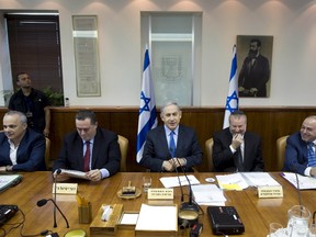 Israel's Prime Minister Benjamin Netanyahu (C) attends the weekly cabinet meeting at his office in Jerusalem July 12, 2015. REUTERS/Abir Sultan