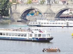 Tourists enjoy a sunny day as they use various boats to cruise the Vltava River in Prague, Czech Republic  in June. Glen Pearson says numerous river recovery projects in Europe are trying to restore rivers after, in many cases, millennia of abuse. (JOE KLAMAR/AFP photo)