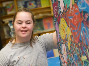Jessie Huggett stands beside one of her pieces of art on Friday, July 17, 2015. Huggett, who lives with Down syndrome, was featured in the Canadian Down Syndrome Society's latest documentary called Picture the Possibilities.
MATT DAY/OTTAWA SUN