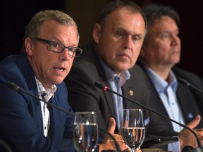Saskatchewan Premier Brad Wall, left, fields a question as Nunavut Premier Peter Taptuna, right, and Yukon Premier Darrell Pasloski look on at the closing news conference of the summer meeting of Canada's premiers in St. John's on Friday, July 17, 2015. THE CANADIAN PRESS/Andrew Vaughan