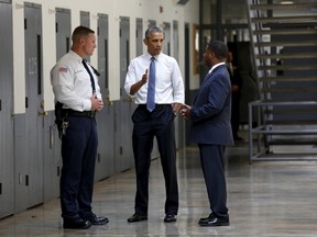 U.S. President Barack Obama tours the El Reno Federal Correctional Institution in El Reno, Oklahoma July 16, 2015. With Obama are Bureau of Prisons Director Charles Samuels (R) and correctional officer Ronald Warwick. Obama is the first sitting president to visit a federal prison. REUTERS/Kevin Lamarque