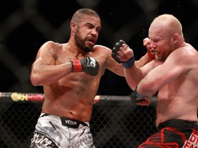 Thales Leites (left) punches Tim Boetsch during a UFC 183 middleweight bout at the MGM Grand Garden Arena on January 31, 2015 in Las Vegas. (Steve Marcus/Getty Images/AFP)