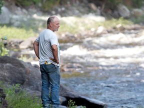 Pierre Cecire stands on the banks of Nigger Rapids along the Gatineau River in Bouchette, Que., on Monday July 13, 2015. 
MATT DAY/OTTAWA SUN