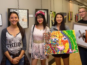 Students Emma Lim, left, Reva Ly, Nicole Di Carlo and Lauren Lee were among those on hand at the opening Friday of an exhibition hosted by Oakridge secondary school visual arts students at 123 King St. in London. Some of the themes the students came up with for the Creating with Pride Youth Exhibition are believing in one?s self, individuality, community, inclusiveness and respect. (MIKE HENSEN, The London Free Press)