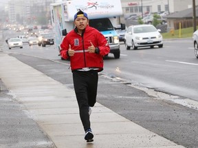 John Lappa/The Sudbury Star
Richard Liang, of Mylan Relay for Hope, runs on the sidewalk on Long Lake Road.