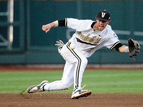 Vanderbilt Commodores shortstop Dansby Swanson tries to field a ball  against the Virginia Cavaliers during the College World Series at TD Ameritrade Park. (Steven Branscombe/USA TODAY Sports)