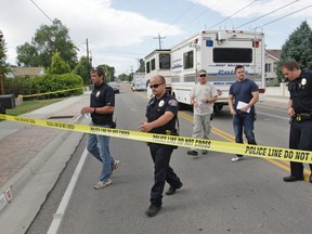 Police officials gather during an investigation after a 12-year-old girl was found dead Friday, July 17, 2015, in West Valley City, Utah. The search for the missing 12-year-old girl is now being investigated as a homicide after West Valley City police discovered the girl's body in a horse pasture. Police Chief Lee Russo says the girl's mother approached two officers at a convenience store near their home around 1:30 a.m. Friday,July 17, 2015. She told officers her daughter had been missing since midnight. (AP Photo/Rick Bowmer)