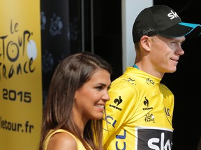 Britain's Chris Froome, wearing the overall leader's yellow jersey, celebrates on the podium of the 14th stage of the Tour de France in Mende, France, on Saturday, July 18, 2015. (Laurent Cipriani/AP Photo)