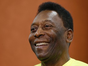 Brazilian soccer legend Pele smiles during a media event at a London restaurant in this March 20, 2015. (AP Photo/Kirsty Wigglesworth,File)