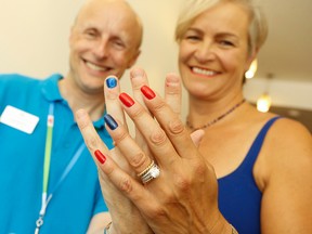 TTC CEO Andy Byford (L) shows off his blue nail polish in a show of support for Ulana Kopystansky  (R) who lost her daughter - Taissa - to cancer 14 years ago. Kopystansky be on a 16-day cycling trek across Canada from Vancouver to Halifax starting September 10 to raising money and awareness towards the Nationals Kids Cancer Ride Saturday July 18, 2015. Jack Boland/Toronto Sun