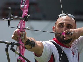 Canada's Jay Lyon prepares to shoot in a semifinal of the men's individual archery, at the Pan Am Games in Toronto, Saturday, July 18, 2015. Lyon won bronze in the event.(AP Photo/Rebecca Blackwell)