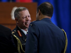 Canada's new Chief of Defence Staff General Jonathan Vance (L) shakes hands with outgoing Chief of Defence Staff General Tom Lawson during a change of command ceremony in Ottawa, Canada July 17, 2015. (REUTERS/Chris Wattie)