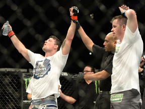Michael Bisping has his hand raised after defeating CB Dalloway during their middleweight bout during UFC 186 at Bell Centre on April 25, 2015. (Eric Bolte/USA TODAY Sports)