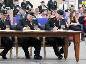 From Left, Lt.-Col. Lester LeBlanc, Brig.-Gen.(ret'd) Glenn Nordick and Col. Stephen Kelsey, officially assign CFB Kingston as the Intelligence Branch Home Station during the Dedication Ceremony in Kingston, Ont. on Saturday July 18, 2015. Steph Crosier/Kingston Whig-Standard/Postmedia Network