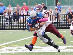 Logan Baronette, left, of the Sudbury Gladiators, is tackled by Mathew Chatelaine, of the Nipissing Wild, during Ontario Football Conference varsity action at James Jerome Sports Complex in Sudbury, Ont. on Saturday July 18, 2015. John Lappa/Sudbury Star/Postmedia Network