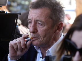 In this Thursday, July 9, 2015 file photo, former AC/DC drummer Phil Rudd arrives for sentencing at the Tauranga District Court in Tauranga, New Zealand. (Alan Gibson/New Zealand Herald via AP, File)