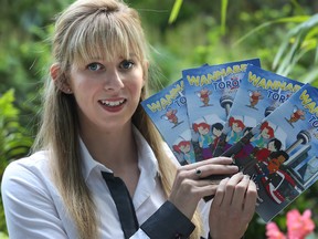 Laura Konkel poses with her Toronto travel guide in Ottawa Wednesday July 8, 2015. (Tony Caldwell/Ottawa Sun)