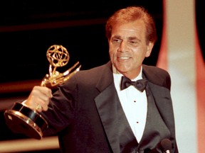In this Sept. 16, 1990 file photo, actor Alex Rocco holds up his Emmy award for best supporting actor in a television comedy series for his role in "The Famous Teddy Z," during his acceptance speech at the 42nd Annual Primetime Emmy Awards in Pasadena, Calif. Rocco, the character actor best known for playing the bespectacled Las Vegas mobster Moe Greene in “The Godfather,” has died, his daughter announced Saturday, July 18, 2015. He was 79. (AP Photo/Nick Ut, File)