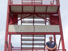 Point Edward's Ian van Reenen, 22, stands triumphant on the tower of the SCOTT FireFit Championships, which were held in Waterfront Park along Livingston Street over the weekend. The event challenges firefighters to compete in a five-part course while wearing full gear.
Photo taken at Sarnia, Ontario on Sunday, July 19, 2015 (CHRIS O’GORMAN/ SARNIA OBSERVER)