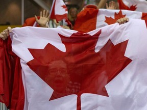Fans wave the Maple Leaf flag as they celebrate after Canada beat Argentina 78-53 in women's basketball at the Pan Am games in Toronto on Friday, July 17, 2015. THE CANADIAN PRESS/Chris Young