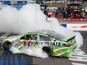 Kyle Busch burns out after winning the NASCAR Sprint Cup series auto race at New Hampshire Motor Speedway on Sunday. (AFP)