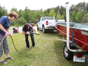John Lappa/The Sudbury Star
Lana Haslam, left, and Anne Labranche, of the environmental planning department with the City of Greater Sudbury, demonstrates how to clean a boat at the Ramsey Lake boat launch on June 25. The event, which was organized by the Greater Sudbury Lake Water Quality Program and the Greater Sudbury Watershed Alliance, was held to emphasize the importance of boaters cleaning their boats to stop the spread of aquatic invasive species from one lake to another lake.