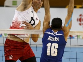 Canada’s Gavin Schmitt sends the ball past Puerto Rico’s Jackson Rivera during their volleyball game at the Pan Am Games Sunday, July 19, 2015. Canada won the match 3-1. (Reuters)