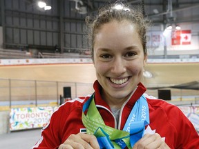 Calgary’s Monique Sullivan shows off the three gold medals she captured  in women’s sprint cycling at the Pan Ams.