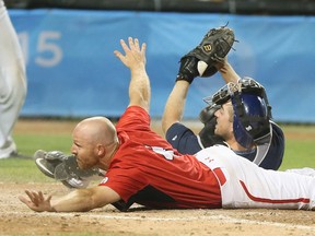 Peter Orr slides into home in the 10th inning as Team Canada wins the gold medal game over the United States at the Pan American Games in Ajax on July 19, 2015. (Veronica Henri/Toronto Sun)