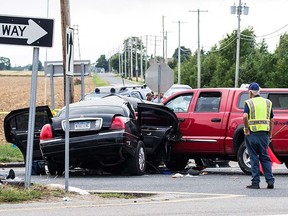 Authorities investigate the scene after a fatal crash between a limousine and a truck Saturday, July 18, 2015, in Cutchogue, N.Y.  (Randee Daddona/Newsday via AP)